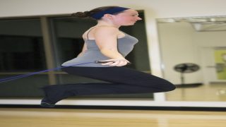 A person jumping rope or doing cardio exercises in a gym