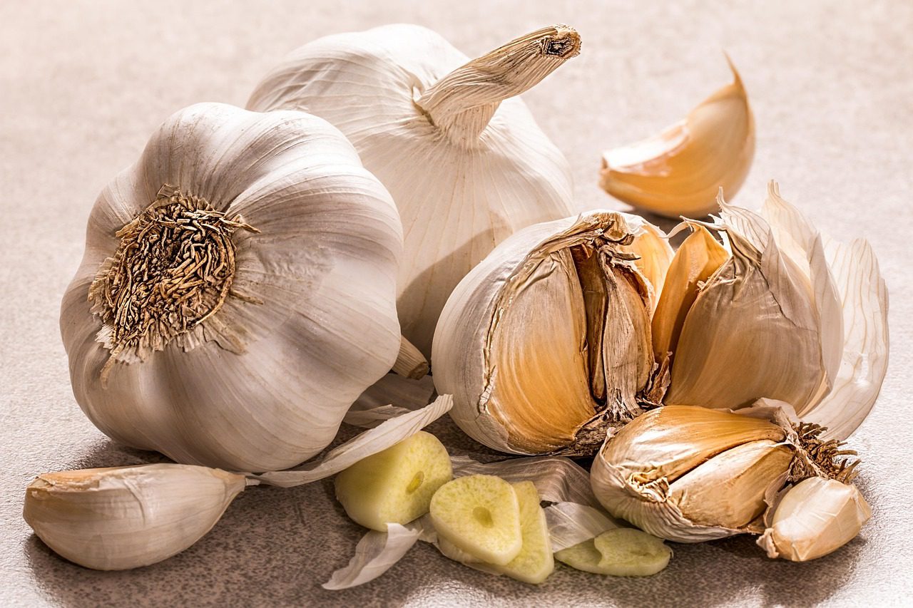 Fresh garlic cloves on a wooden cutting board