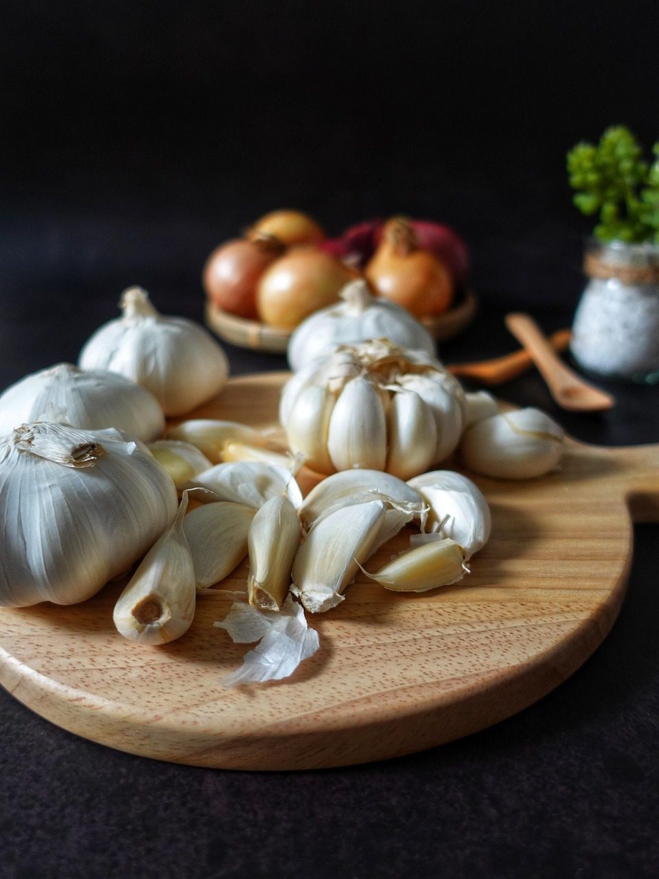 Fresh garlic cloves on a wooden cutting board