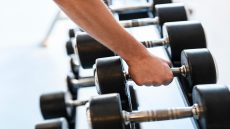 Beginner doing strength training with dumbbells in the gym