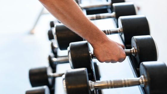 Beginner doing strength training with dumbbells in the gym